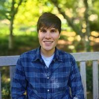 portrait of Paul Merritt outside on a bench